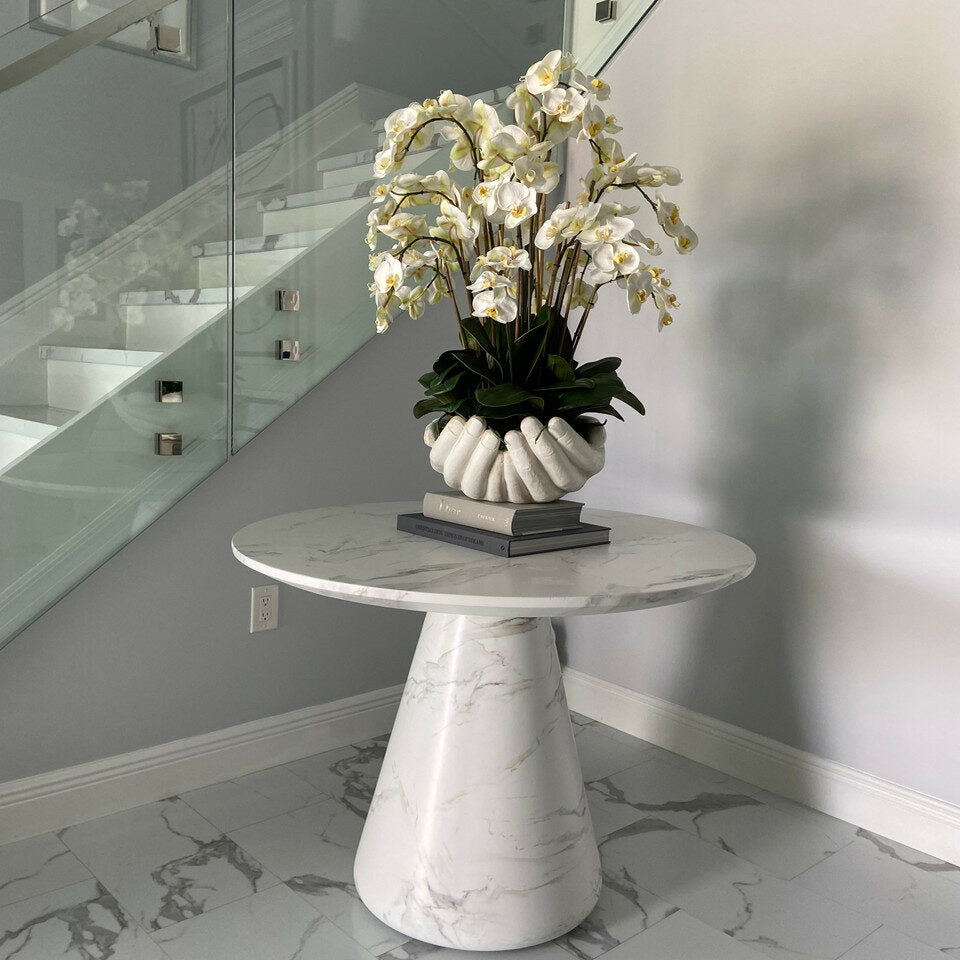 White Phalaenopsis orchids in a vase, open hands sculpture