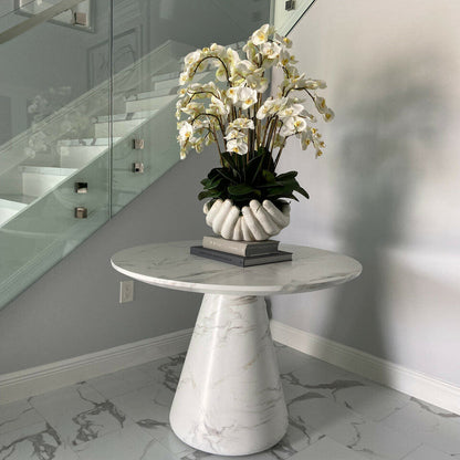 White Phalaenopsis orchids in a vase, open hands sculpture