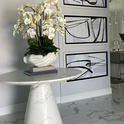 White Phalaenopsis orchids in a vase, open hands sculpture