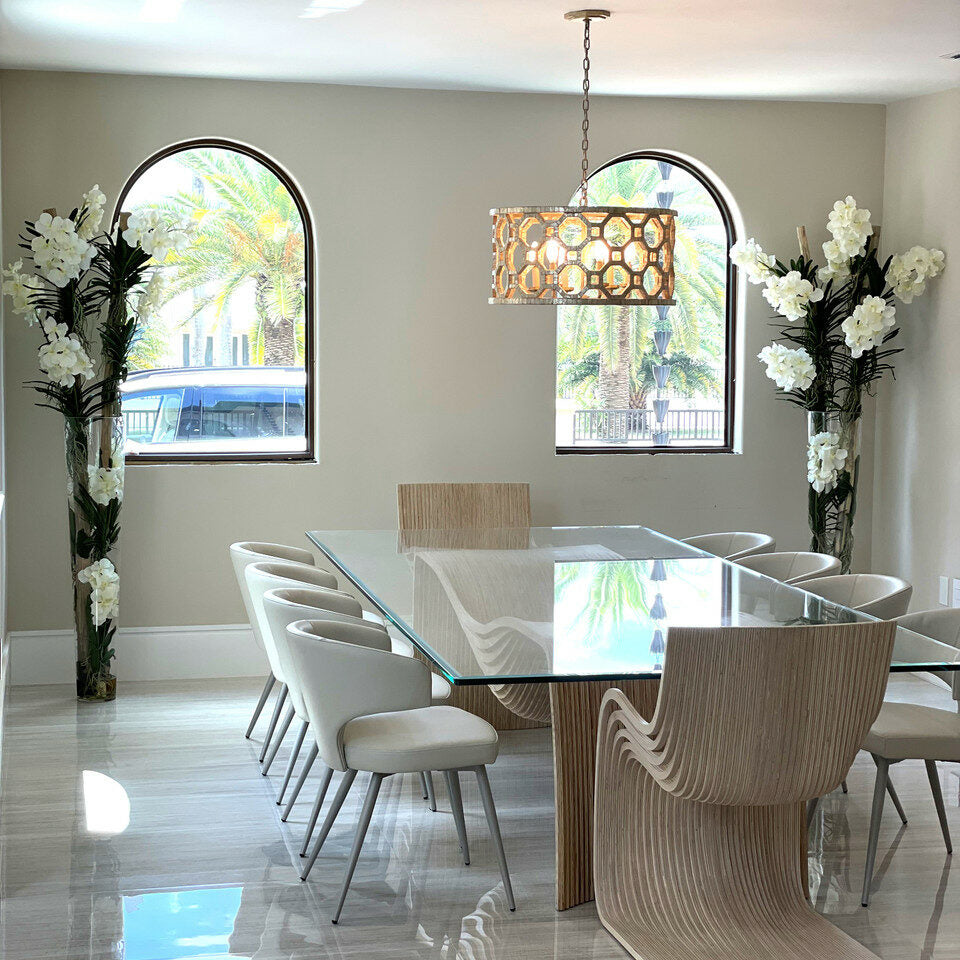 White Vanda orchids and driftwood inside large conical glass cylinder